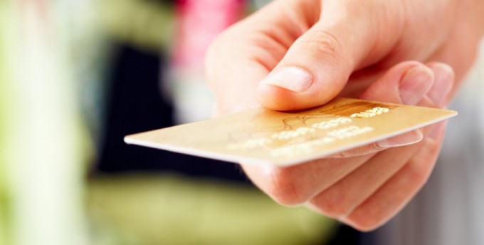 Close-up of credit card in human hand in the shop