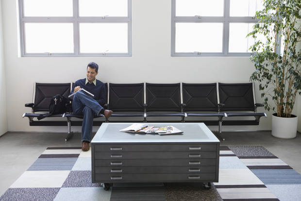 Businessman sitting in lobby of office